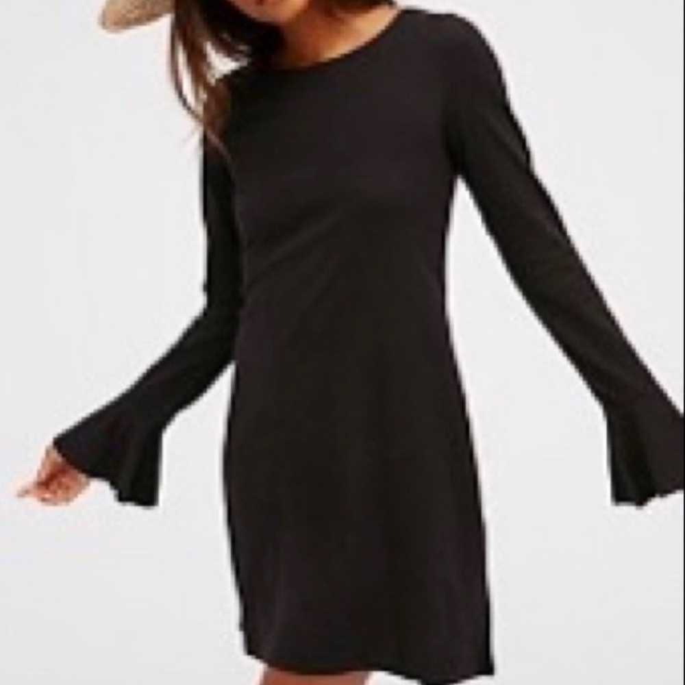 XS Free People mini, black dress with open back and bell sleeves.